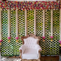 Another variation of our popular woven leaf backdrop, this time decorated with colorful floral garlands. We customize the flower arrangements to match your preferred color scheme.