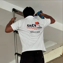 A close-up of my technician installing a camera. Notice the branded t-shirt, a mark of our professional and accountable team.