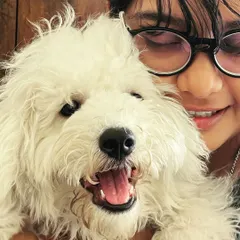 This is one of us with the adorable Snowy. We are always around to give cuddles and make sure your dog never feels lonely. Seeing them happy and comfortable is the best part of our day.