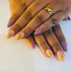 A full view of the beautiful birthday nails, a mix of purple and peach with gold foil.
