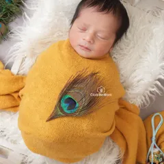 A peaceful portrait of our baby Kanha, snugly wrapped and dreaming sweet dreams. I focus on creating a calm atmosphere to capture these serene expressions.