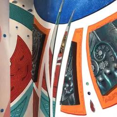 A close-up of the mixed-media mural, showing the hand-painted abstract shapes alongside custom-made 3D fiber art pieces. This technique adds physical depth and texture to the wall.