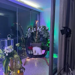 For this anniversary decoration, we decorated a balcony swing chair with lush greenery and white flowers. The addition of fairy lights and lanterns created a romantic and cozy nook for the couple.
