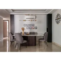 In this dining room, our 6-seater table with a white Statuario marble top and fluted oak wood base is the centerpiece. The design is minimalist yet functional, creating a perfect harmony of form and utility.
