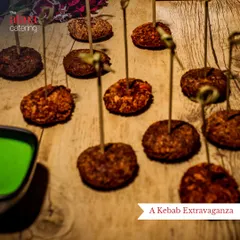 A kebab extravaganza featuring various vegetarian kebabs on skewers. Served with a vibrant green chutney, these are perfect for passing around at any party.