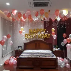 A classic surprise birthday decoration, filling the bedroom with helium balloons floating on the ceiling.