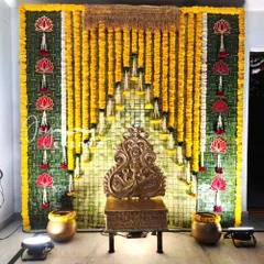 This traditional backdrop for a half saree ceremony is made from coconut leaves and marigold garlands. We added hanging lotus motifs and an antique-style throne to complete the authentic look.