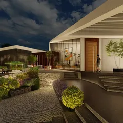 The entrance to the farmhouse features a mix of cobblestone paths, multi-level landscaping, and warm lighting. This careful attention to the journey creates a welcoming and impressive arrival experience.
