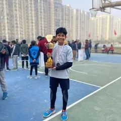 Seeing the pride on a player's face after a tournament win is what motivates us. This young champion from our academy is holding his trophy after a stellar performance in the winter league.