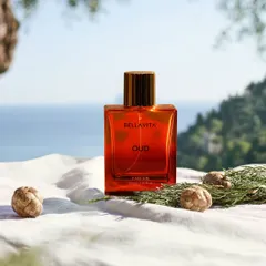 A lifestyle product shoot for a perfume brand, set against a natural, scenic backdrop to evoke a feeling of luxury and escape, connecting the product to a desirable experience.