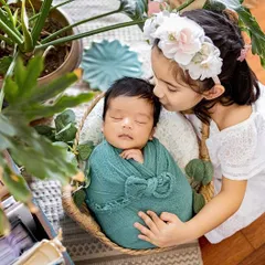 A big sister's first kiss for her new baby brother. Capturing the bond between siblings from the very beginning is one of my greatest joys. This posed newborn and sibling photo is a memory this family will hold dear forever.