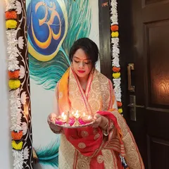 Holding a thali of diyas, this look captures the essence of Diwali. The outfit's rich colors and traditional design are perfect for festive rituals.