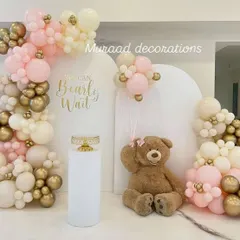 The 'We can Bearly Wait' theme is perfect for a sweet and cozy baby shower. This setup includes arched backdrops, a cute teddy bear prop, and a balloon arrangement in soft pink, cream, and gold.