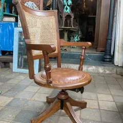 A vintage-style swivel office chair I customized for a client. It's made from solid teak with a caned backrest and a comfortable leatherette seat, combining ergonomic function with classic design.