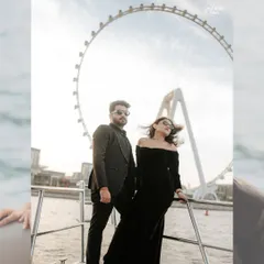 A power-couple portrait on a yacht in Dubai, with the iconic Ain Dubai ferris wheel in the background. This shot captures the luxurious and glamorous side of a destination pre-wedding shoot.