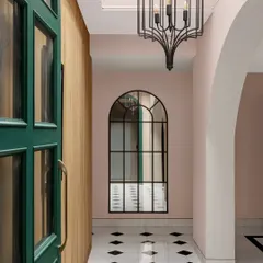 The entrance foyer of the Quiet Ornate home features a fluted wood wall with concealed storage, combining beautiful texture with smart functionality. The classic marble inlay floors add a timeless, graphic element.