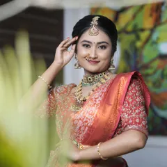 A closer look at the bridal makeup, showing the detailed eye work, traditional bindi, and how the HD foundation creates a smooth finish. I ensure every detail, from the maang tikka placement to the nose ring, is perfect for your big day.