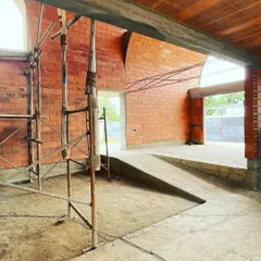The interplay of ramps and steps within the brick-vaulted house. The design creates a dynamic journey through spaces that are defined by light and material.
