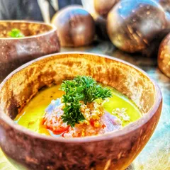 This dish features fragrant Blue Jasmine Rice paired with a creamy Vietnamese curry, served in a rustic coconut bowl. It's an example of the authentic and beautifully presented global cuisine I offer.