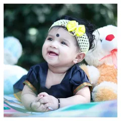 An adorable close-up from an outdoor baby milestone session. We can include different outfits, like this beautiful traditional dress, and props like teddy bears to add personality to the photos.