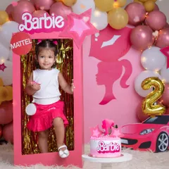 A life-sized Barbie box makes for the perfect prop. This little girl is living her Barbie dream during her special second birthday photoshoot.
