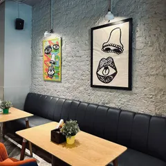 I wanted the cafe to have its own unique personality. The space is decorated with quirky, modern art and offers comfortable booth seating, making it a cool and inviting spot for a meal or coffee.