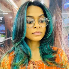 A front view of our stunning turquoise color service. The placement of the highlights frames the face beautifully, making this a truly customized and expressive hairstyle.