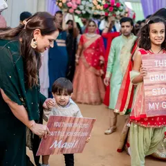 The little ones often steal the show, and we make sure they are part of the story. Capturing children with their cute, funny signs during the wedding procession adds a layer of warmth and humor to the day's memories.
