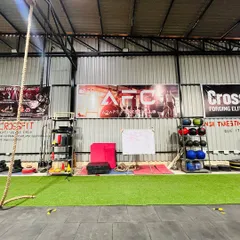 This is the heart of our training center. The open green turf area is perfect for warm-ups and drills, while the background shows our medicine ball rack, whiteboard for daily workouts, and the main AFC banner.