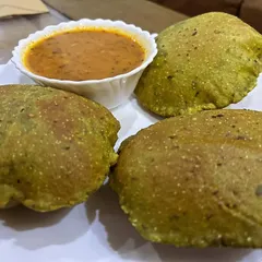 A healthy twist on a classic, these are Palak Pooris served with Aloo Sabzi. The spinach adds nutrition and a beautiful color to the pooris.