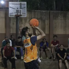 A player lines up a crucial free throw with the crowd watching. Focus and precision are key in these high-pressure moments.