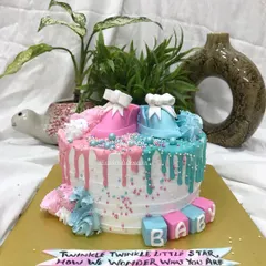 A full shot of the pink and blue baby shower cake, perfect for celebrating the little one on the way.