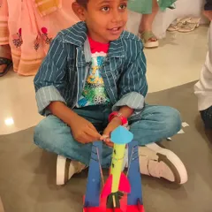 A young explorer looks on with anticipation, ready to launch the rocket he just built. This activity teaches the basics of aerodynamics and potential energy.