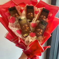 The only thing better than chocolate is more chocolate! This bouquet is made with Cadbury Temptations bars, red decorative hearts, and a vibrant red wrap for the ultimate sweet tooth gift.