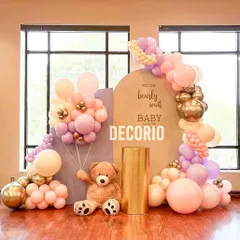 For this "We Can Bearly Wait" baby shower, I used a warm palette of pinks and golds against a neutral backdrop. The teddy bear holding a balloon bunch adds a touch of whimsy to this elegant setup.