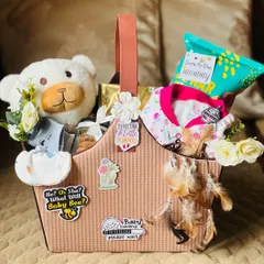 A beautifully curated basket for an expecting mom. I've combined a soft teddy bear and baby essentials with snacks and decorative flowers, adding fun stickers to celebrate her journey to motherhood.