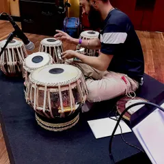 Making final adjustments to the tuning of my tablas during soundcheck. Each drum needs to be perfectly tuned to the key of the performance.
