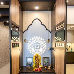 This elegant pooja unit features a folding cabinet design with intricate metal bells and a stunning backlit mandala pattern, creating a divine focal point that is both traditional and contemporary.