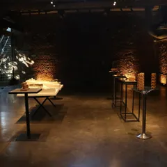 The exhibition space at IF.BE, where the raw, historic character of the building is preserved. The dark, atmospheric interior allows the architectural models to stand out as sculptural objects, demonstrating how heritage spaces can be adapted for contemporary use.