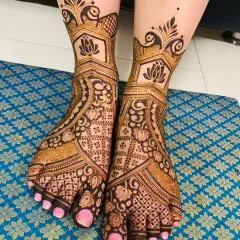 A clean and elegant foot design featuring lotus and peacock motifs. The patterns are spaced out to create a graceful look that is both traditional and not overly heavy.