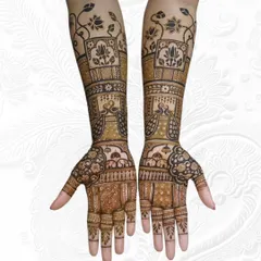 A full view of an engagement mehendi design. It features lotus and peacock motifs, extending gracefully up the arms.