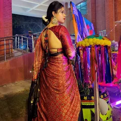 The back of this lehenga blouse features a stunning, deep-cut design with tassels, adding a touch of modern allure to a traditional Navratri outfit.