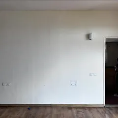 Before: The master bedroom in 'Cover me in Sunshine' was a blank canvas with a plain wall and a standard door to the bathroom.