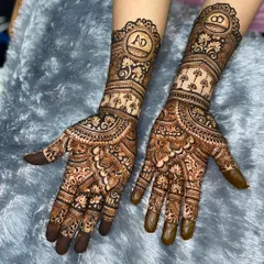A beautiful engagement design personalized with the couple's initials, 'A' and 'D', enclosed in ornate circles at the center of each palm.
