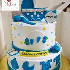 A two-tiered welcome cake for a baby boy, personalized with his birth time, date, and weight.