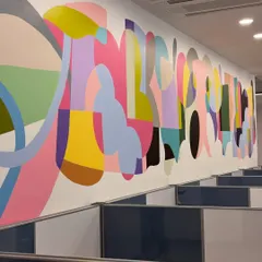 This 42-foot abstract mural in a commercial office space is inspired by global movement and individuality. The vibrant colors and fluid shapes represent the beauty of different identities coexisting in a shared, creative environment.
