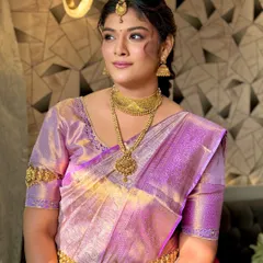 A classic portrait of a South Indian bride. The makeup is kept elegant and timeless, with a focus on defined eyes and a flawless base to complement the rich gold jewelry.