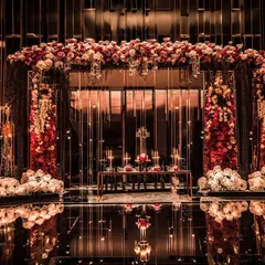 A closer look at the reception decor, where a magnificent floral arch frames a mirrored wall. The reflection of the flowers and candles creates an illusion of infinite depth and opulence.