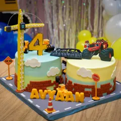 An incredible construction-themed cake, complete with edible roads, signs, a crane, and a monster truck. It's a work of art!