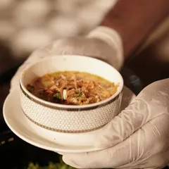A perfectly prepared bowl of Khow Suey is presented with care. The rich, coconut-based broth and medley of textures make this a comforting and satisfying dish that transports guests to Southeast Asia.